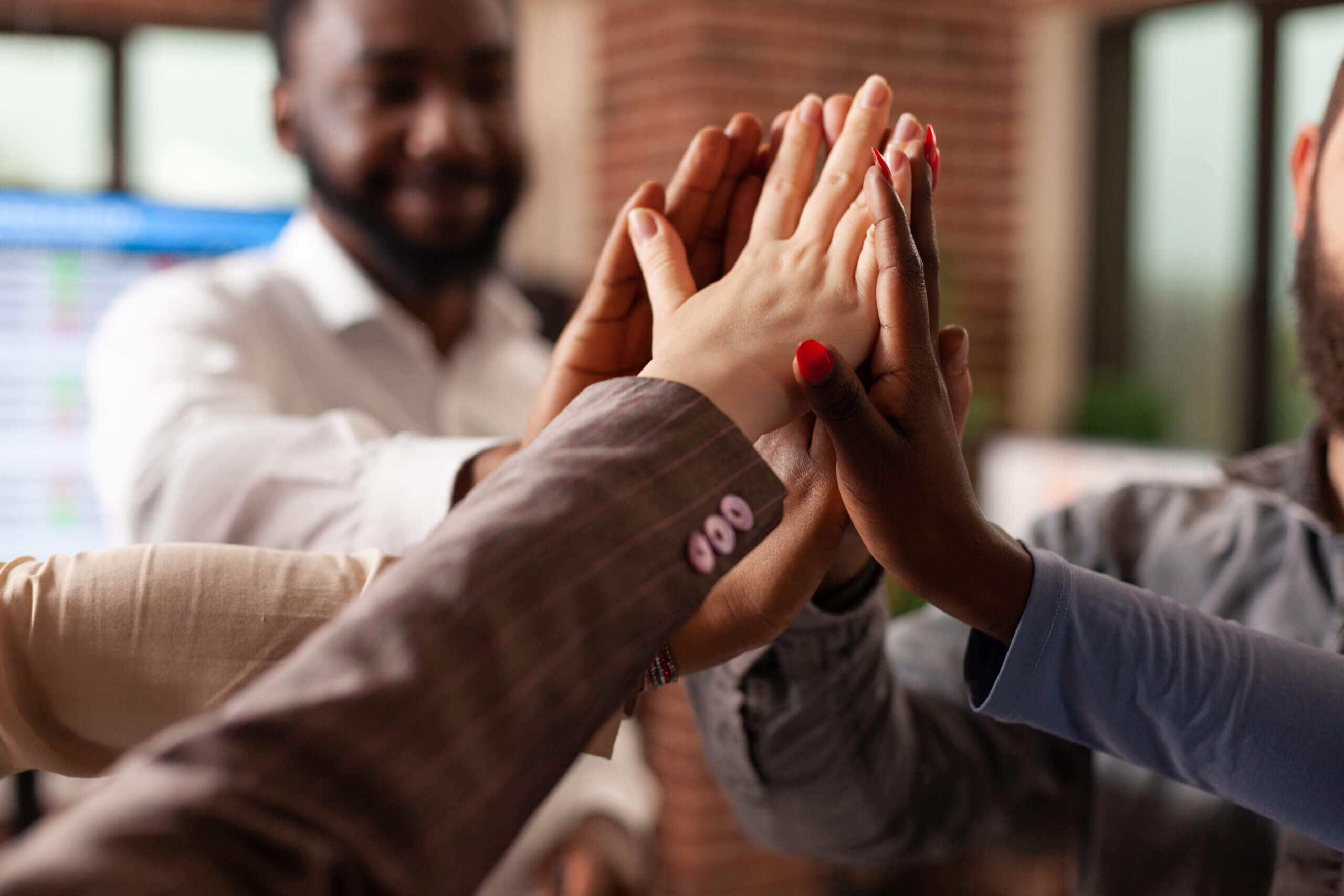 A group of people with their hands in the air.